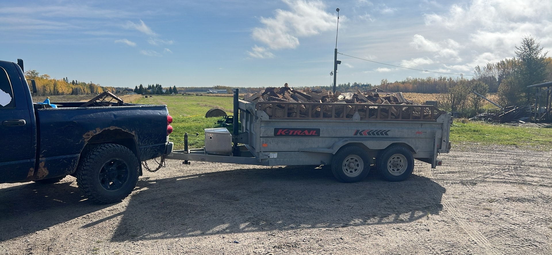 Firewood delivery truck parked at a rural home